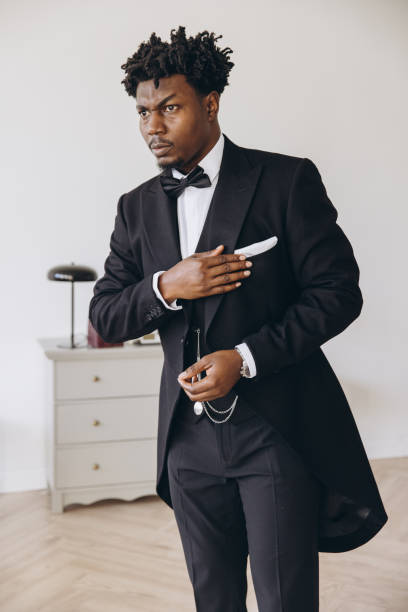istock Elegant groom adjusting his suit before wedding ceremony 2191407947