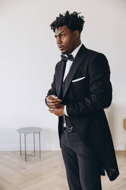 istock Elegant groom adjusting his suit before wedding ceremony 2191407964