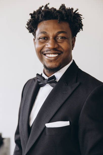 istock Elegant businessman wearing suit and bow tie smiling confidently 2191408079