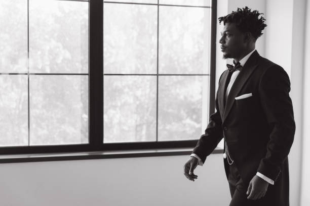 istock Elegant businessman walking in a modern office with trees outside the window 2191408143