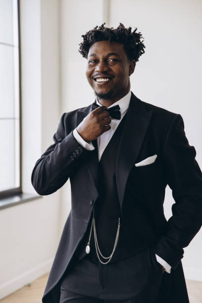 istock Elegant groom adjusting bow tie before wedding ceremony 2191408446