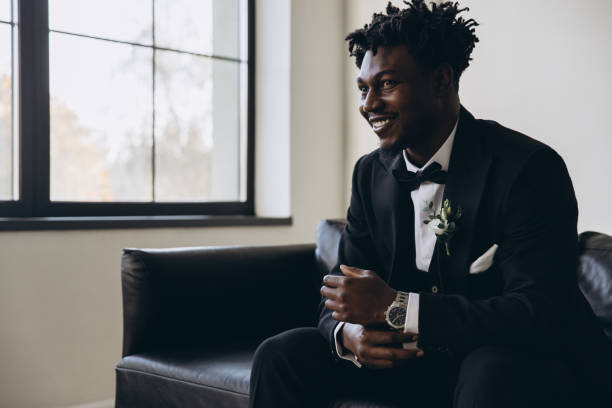 istock Groom wearing elegant suit sitting on sofa and waiting for bride 2191408479