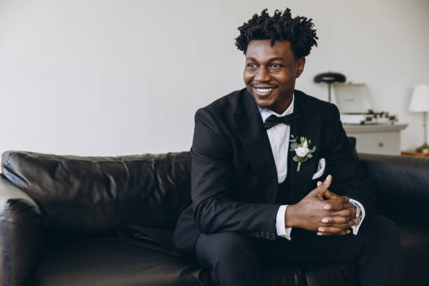 istock Groom smiling and waiting on sofa before wedding ceremony 2191408499