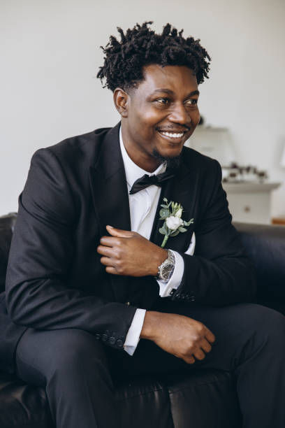 istock Elegant groom smiling and sitting on a couch before wedding 2191408505