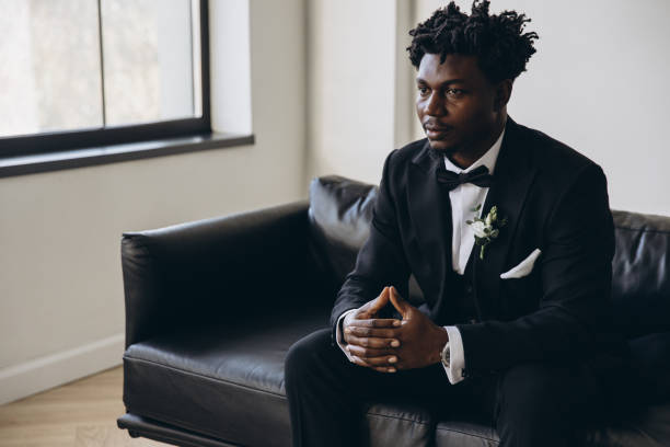 istock Groom sitting on couch waiting for bride, wedding day preparation 2191408529