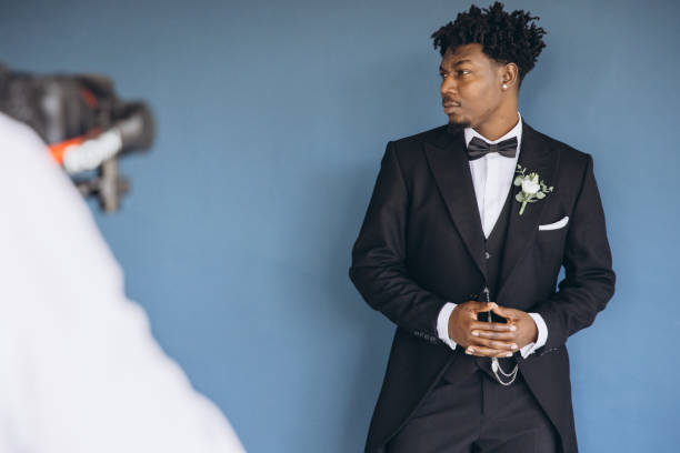 istock Videographer Filming Groom Wearing Tuxedo During Wedding Preparation 2191408577
