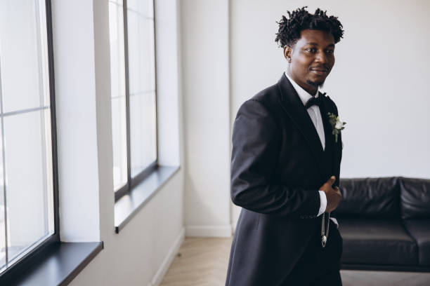 istock Elegant groom adjusting his suit while waiting for the bride 2191408687