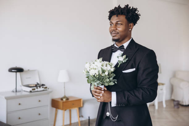 istock Groom holding bouquet is waiting for the bride before interracial wedding ceremony 2191408714