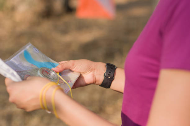 istock Unrecognizable Woman hands using compass and map during orienteering race. Latin young 2191408766