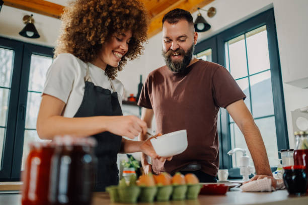istock Happy couple preparing food in modern kitchen 2191409394