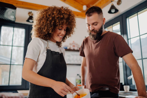 istock Couple cooking together in modern kitchen, preparing a delicious meal 2191409467
