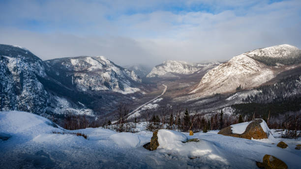 Hiking the Charlevoix snow covered mountains in winter, view over the valley of Grands-Jardins national park, Quebec, Canada