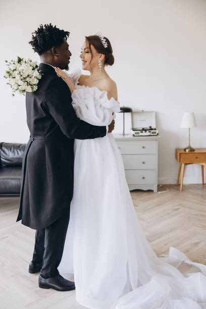istock Groom and Bride Embracing at Their Interracial Wedding 2191409764