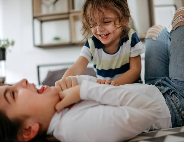 istock Brother and sister are playing on the bed 2191409793