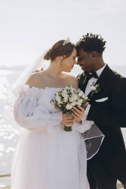 istock Interracial Couple Getting Married by the Sea 2191409825