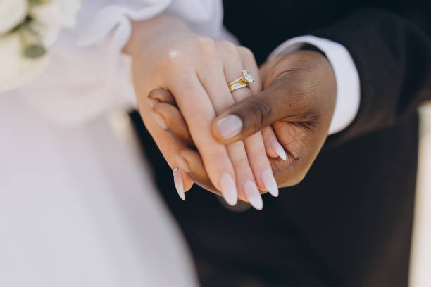Interracial Couple Holding Hands Showing Wedding Rings