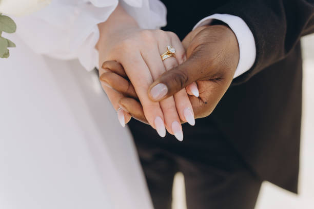 istock Interracial Couple Holding Hands Showing Wedding Rings 2191409829