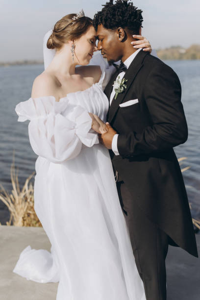 istock Interracial couple getting married near a lake 2191409845
