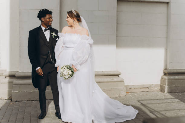 istock Interracial Couple Smiling During Wedding Ceremony Outside Church 2191409888