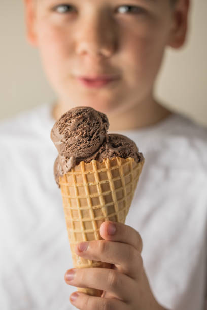 An elderly man's hand with an ice cream in a packaging