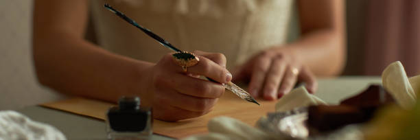istock Close Up of Ladys Hand Writing Letter Header 2191410690