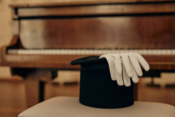 istock Top Hat and Gloves on Piano Chair 2191410703