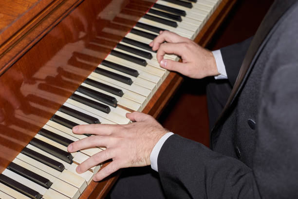 fingers of a man playing the piano