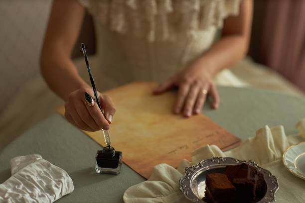istock Lady Writing Letter Holding Ornate Ink Pen 2191410788