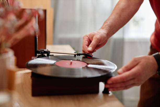istock Senior Man Setting Up Retro Record Player at Home 2191411120