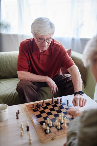 istock Senior Man Playing Chess with Wife 2191411133