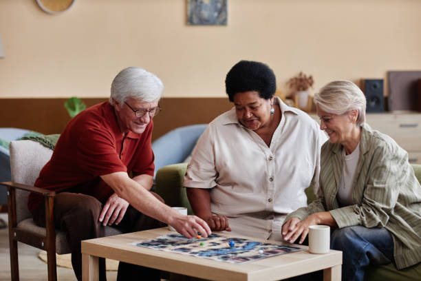 Senior People Playing Board Game in Living Room