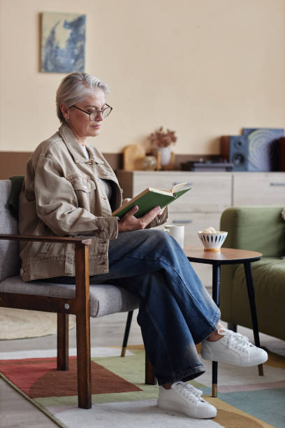 istock Senior Woman reading Book 2191411168
