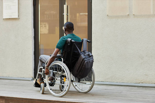 istock Back View Man using Wheelchair Opening Door 2191411472