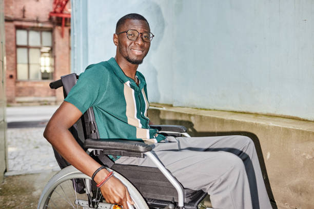 istock Smiling Man using Wheelchair in City Smiling At Camera 2191411503
