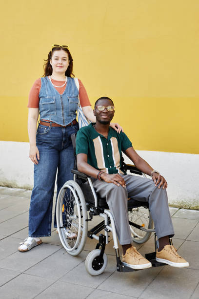 istock Man with Disability using Wheelchair Posing with Friend 2191411507