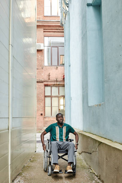 istock Wide Angle Black Man using Wheelchair in City 2191411513