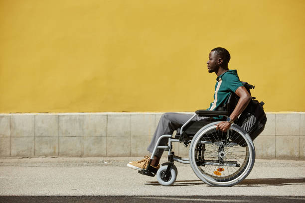 Wide Angle Black Man with Disability using Wheelchair in City