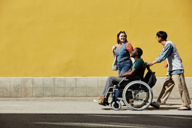 istock Wide Angle Group of Friends with Black Man using Wheelchair 2191411533