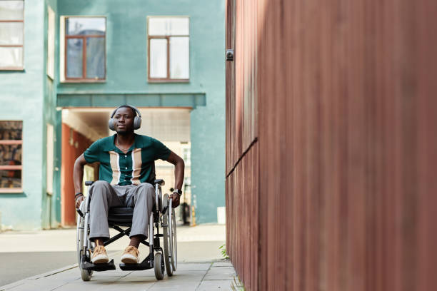 istock Urban Scene with Man in Wheelchair 2191411534
