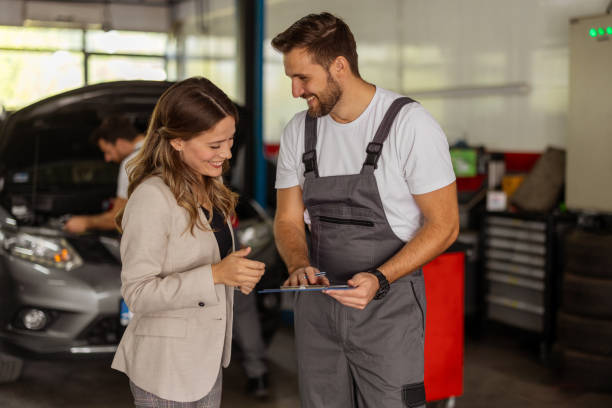 istock Professional Mechanic Explaining Repair Process to Woman 2191413855