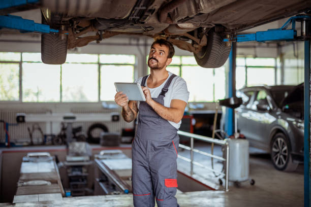 istock Mechanic Using Digital Tablet to Analyze and Repair Car's Undercarriage 2191413866