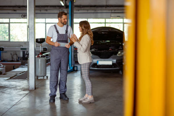 istock Mechanic and Female Client Analyze Repair Choices in Workshop 2191413918