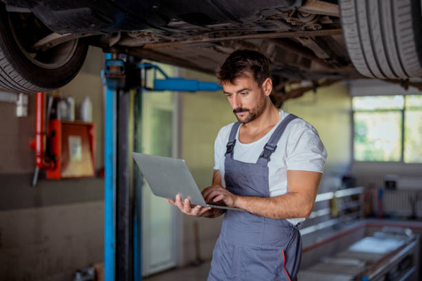 istock Mechanic Using Laptop for Undercarriage Analysis and Repair in Workshop 2191413949