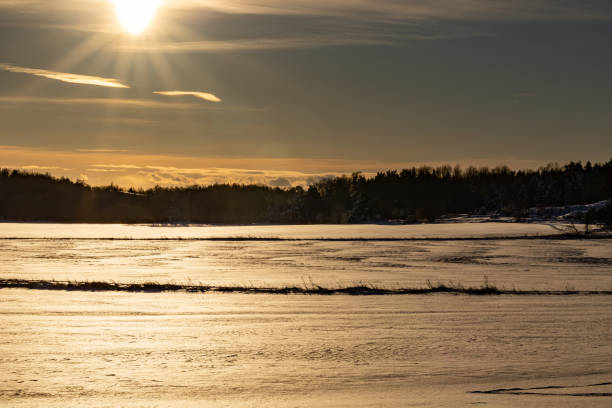 Gamla Uppsala, Sweden An icy land winter landscape at sunset close to the Royal Mounds.