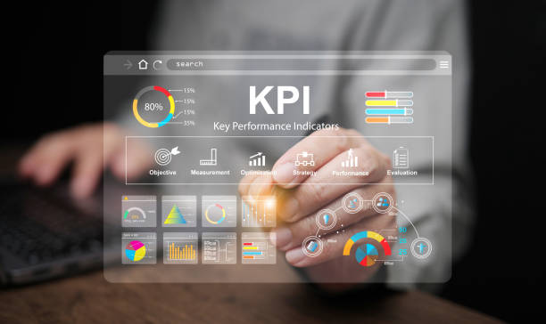KPI key performance indicator. A businessman with a stylus tapping on virtual screen to use KPIs to measure progress of his business, project, or work over time to reach the goals