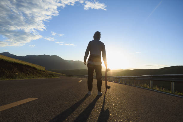 istock Skateboarder skateboarding on the mountain road 2191416625