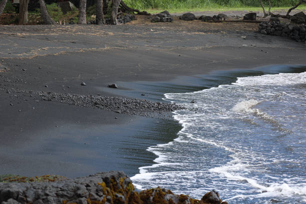 Black beach with black sand and clear blue water at Lanzarote, Canary Islands, Spain