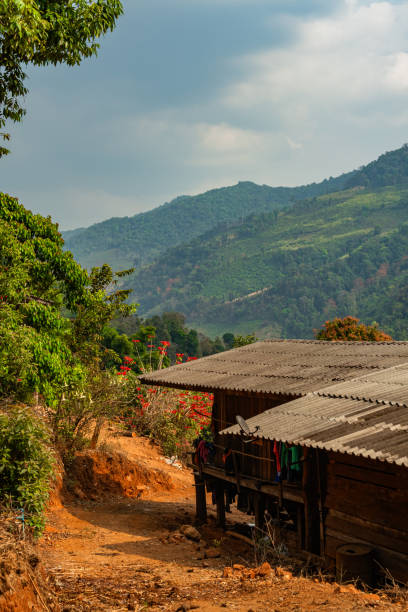 istock Wooden house situated on a dirt path surrounded by greenery and mountains, Mae Hong Son, Thailand 2191423472
