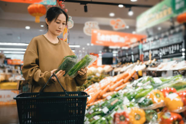 istock Exploring Fresh Produce: A Woman's Journey in a Vibrant Supermarket 2191423978