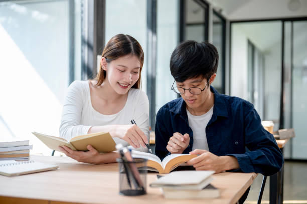 istock Two young Asian college students are studying and preparing for an exam together in a coffee shop. 2191425721